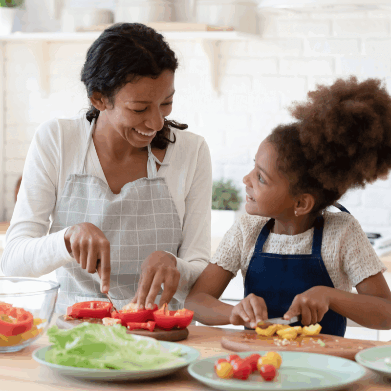 mum talking with her kid while preparing food in the kitchen